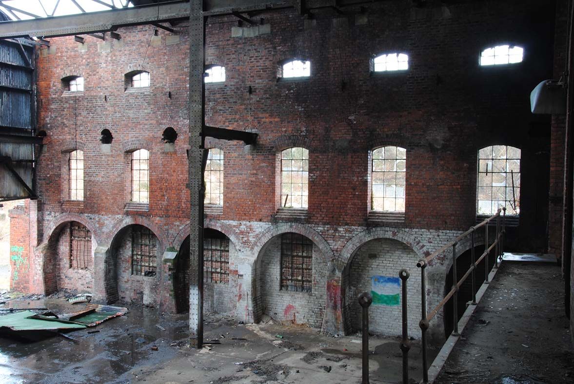 Internal walls of an old power station in a state of disrepair