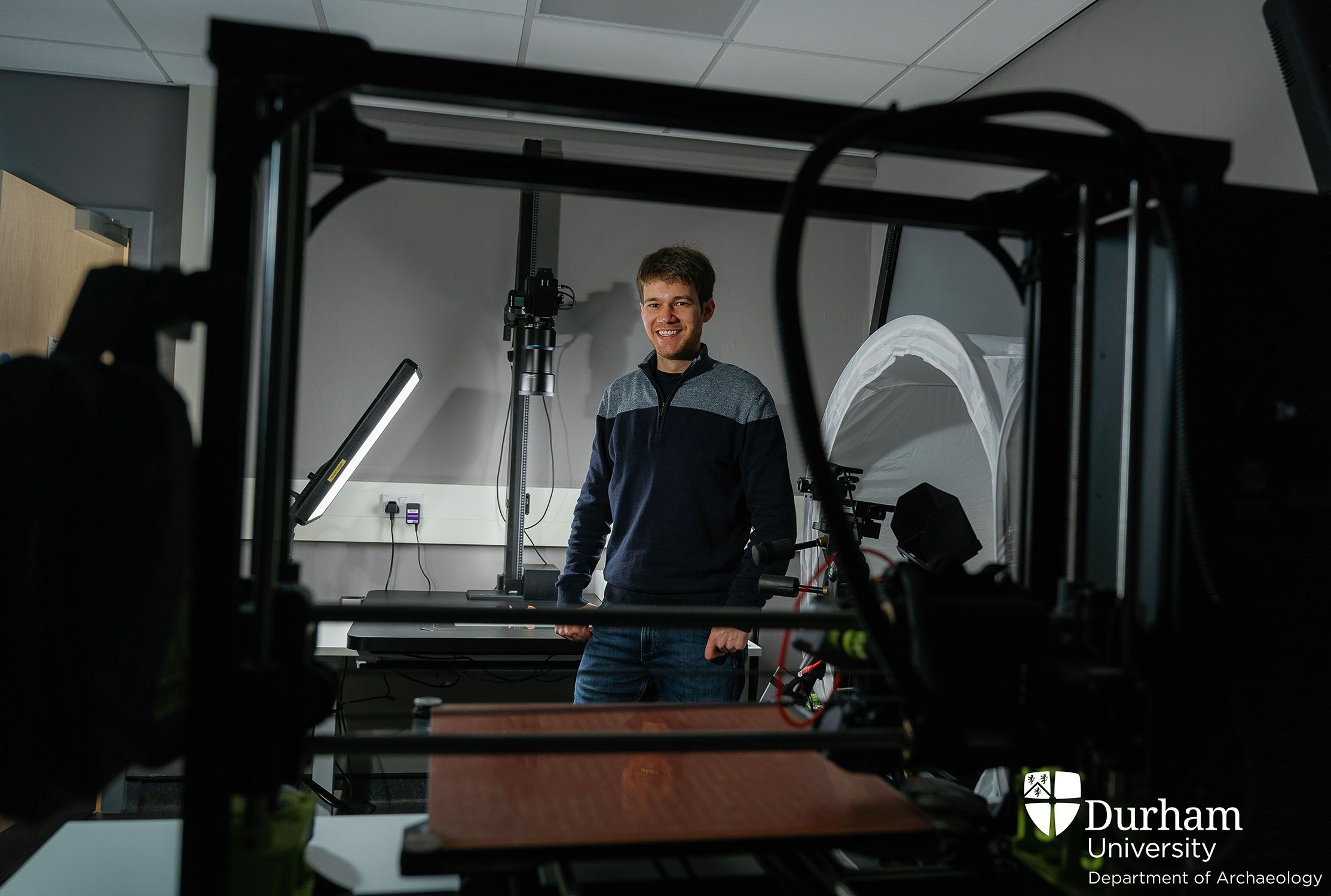 Alexander Jansen stands in the Digital Visualisation Lab and smiles at the camera.