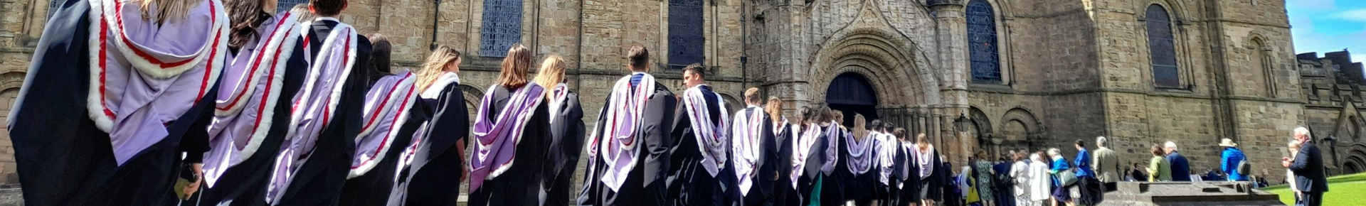 Students in gowns entering Durham Cathedral