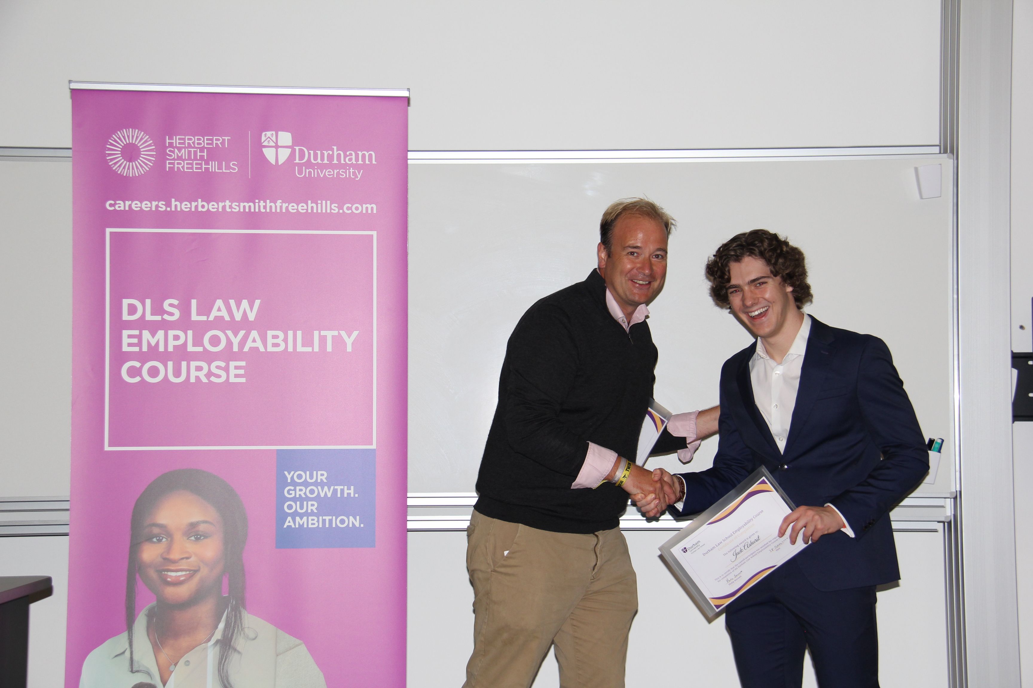 Michael Aherne, Partner, Herbert Smith Freehills presenting Jack Ashurst, member of the first team to finish the course, with his 2023/24 Employability Completion of Course Certificate