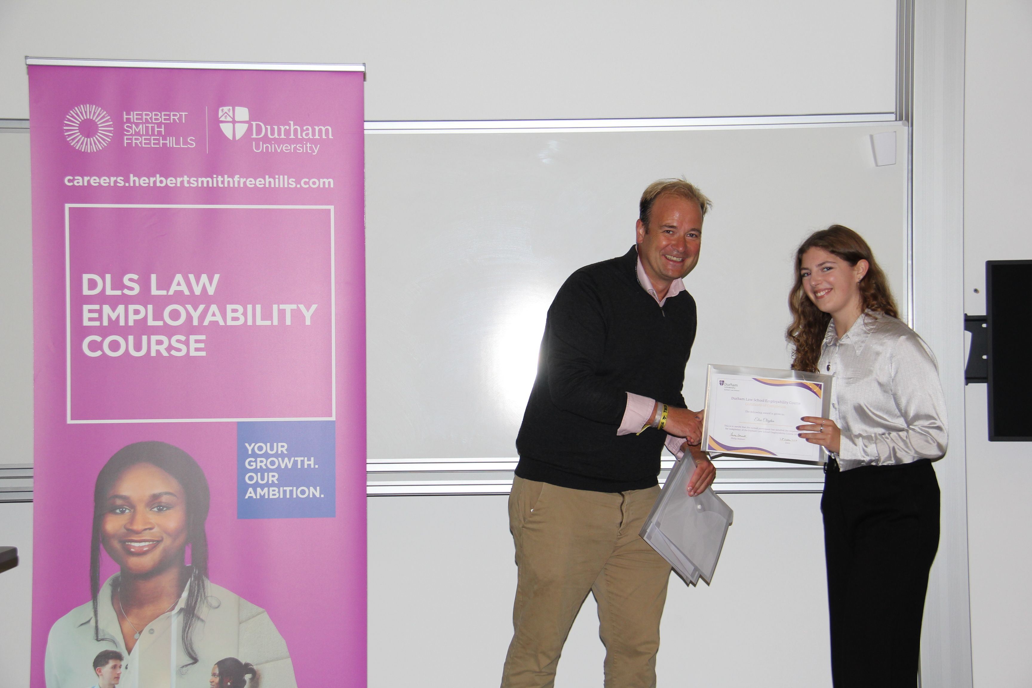 Michael Aherne, Partner, Herbert Smith Freehills presenting Elise Clayton with her 2023/24 Employability Completion of Course Certificate