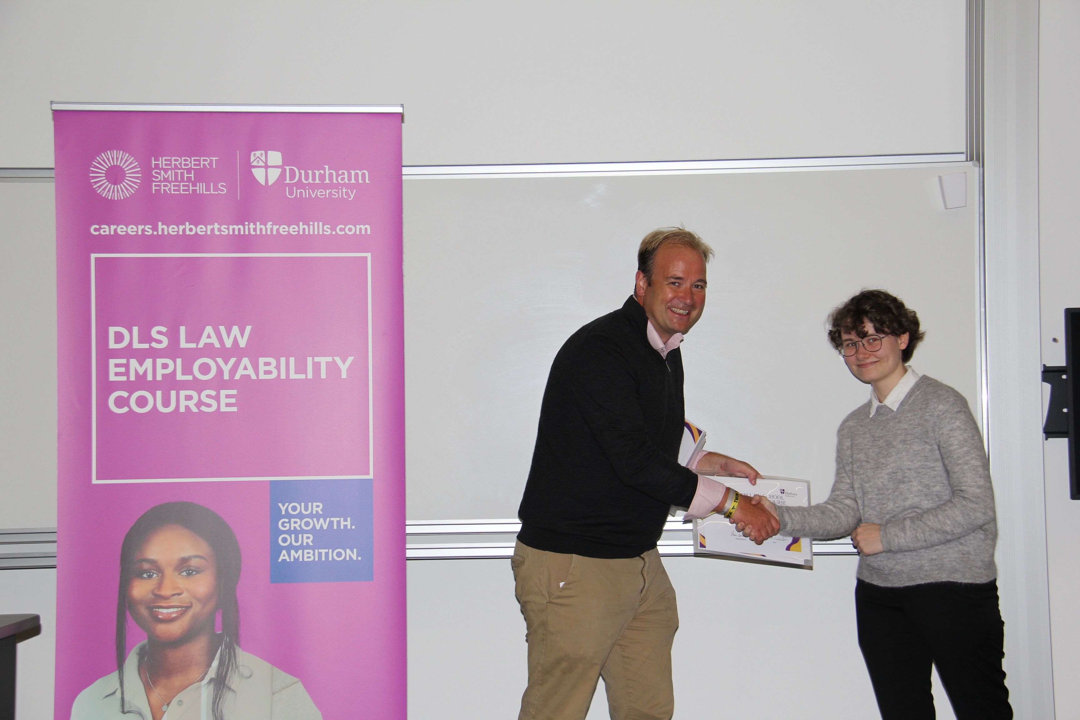 Michael Aherne, Partner, Herbert Smith Freehills presenting Felix Andersson with his 2023/24 Employability Completion of Course Certificate