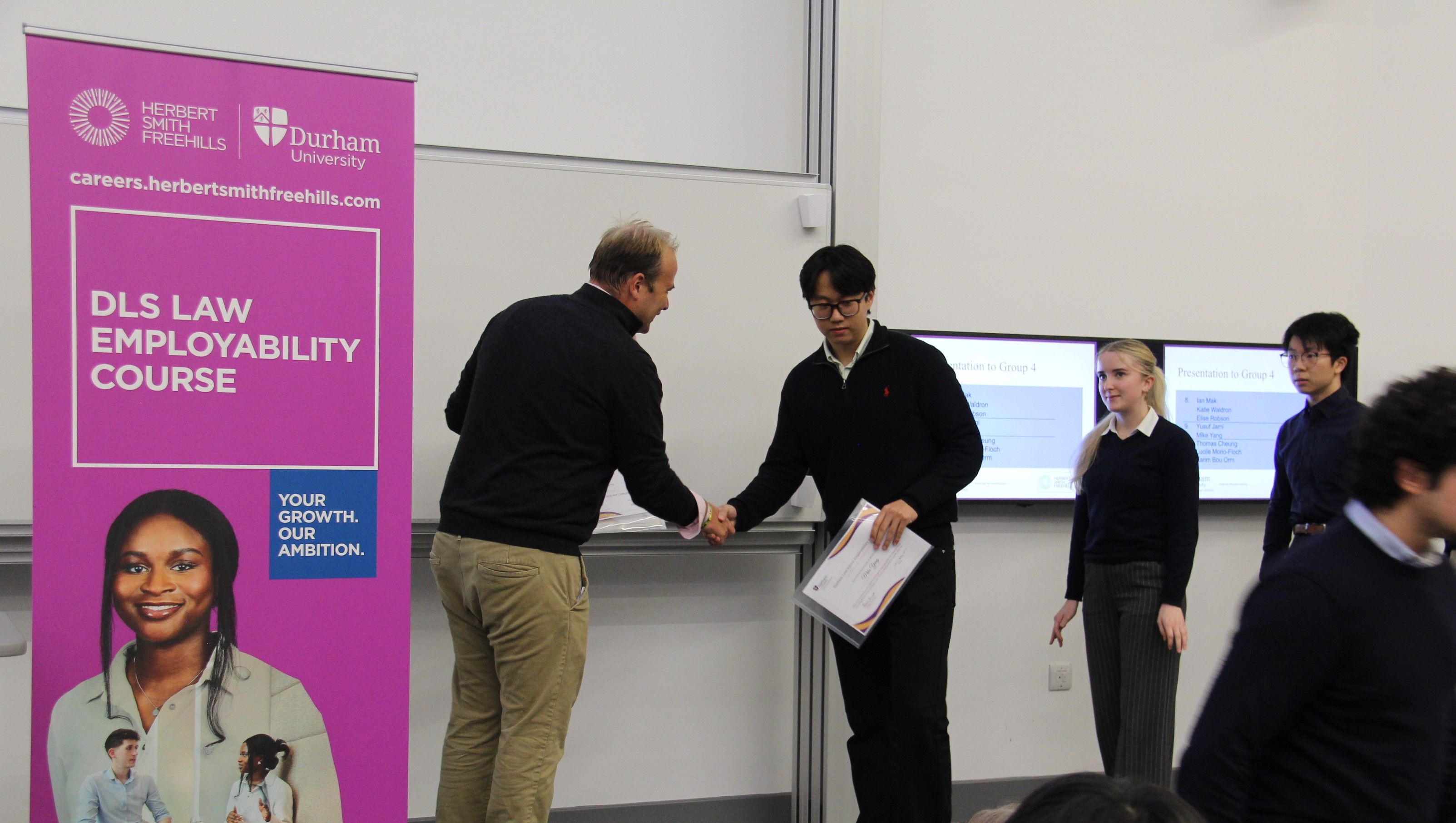 Michael Aherne, Partner, Herbert Smith Freehills presenting Mike Yang with his 2023/24 Employability Completion of Course Certificate