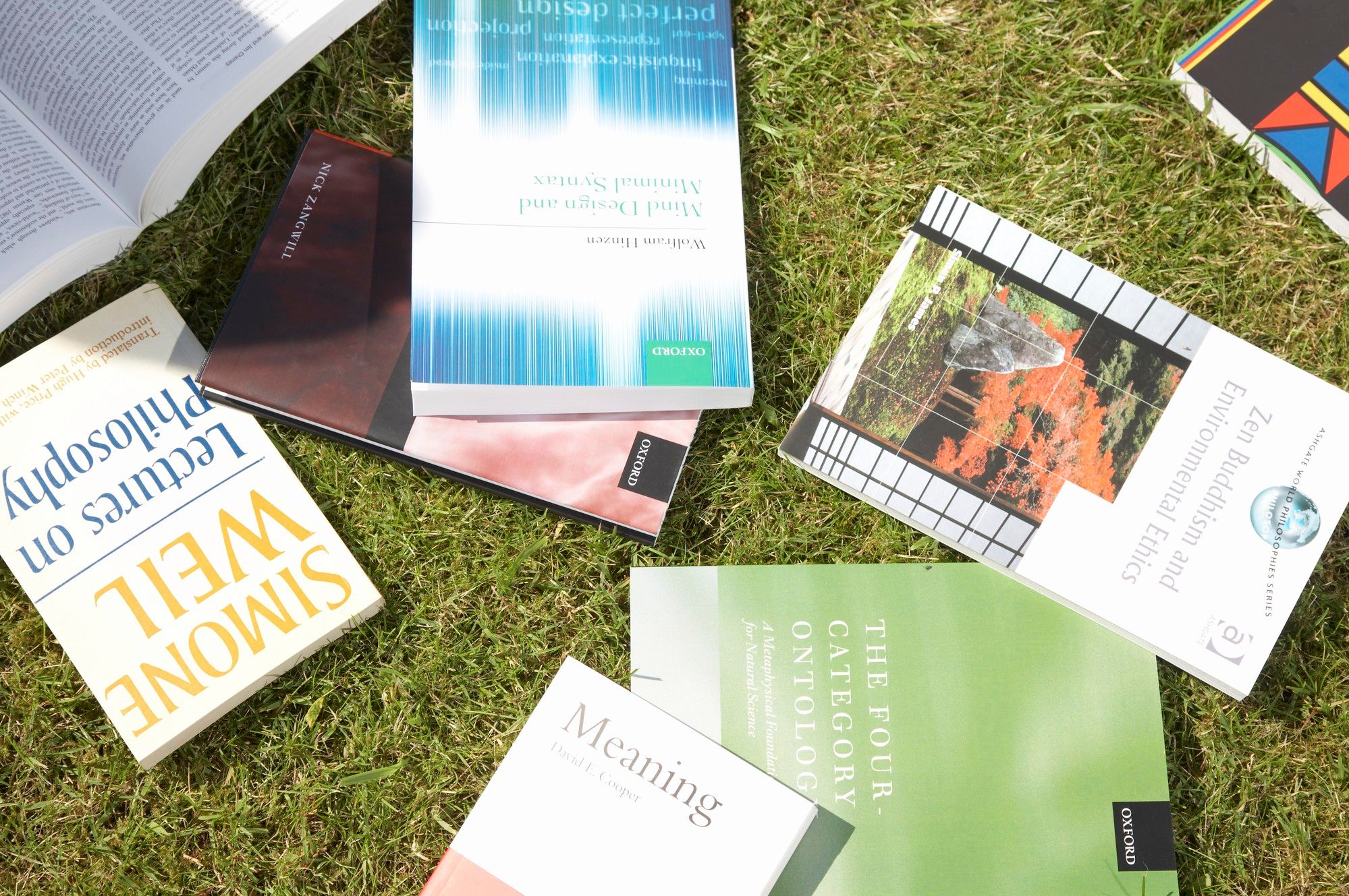 Philosophy books placed on grass