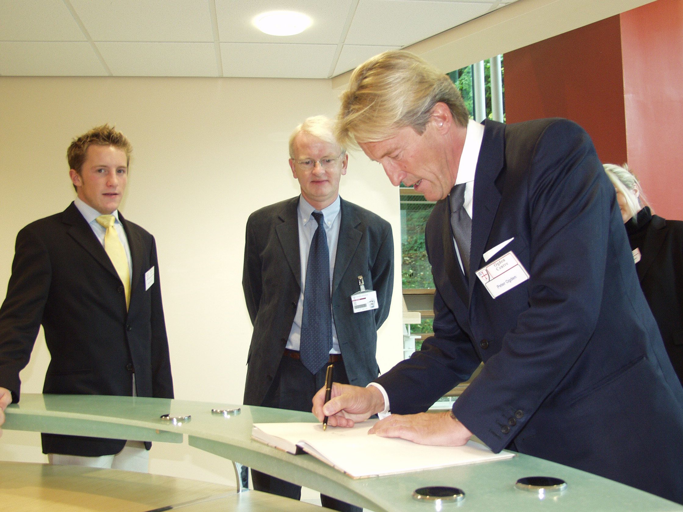 Sir Peter Ogden signs the register whilst opening the Ogden East building
