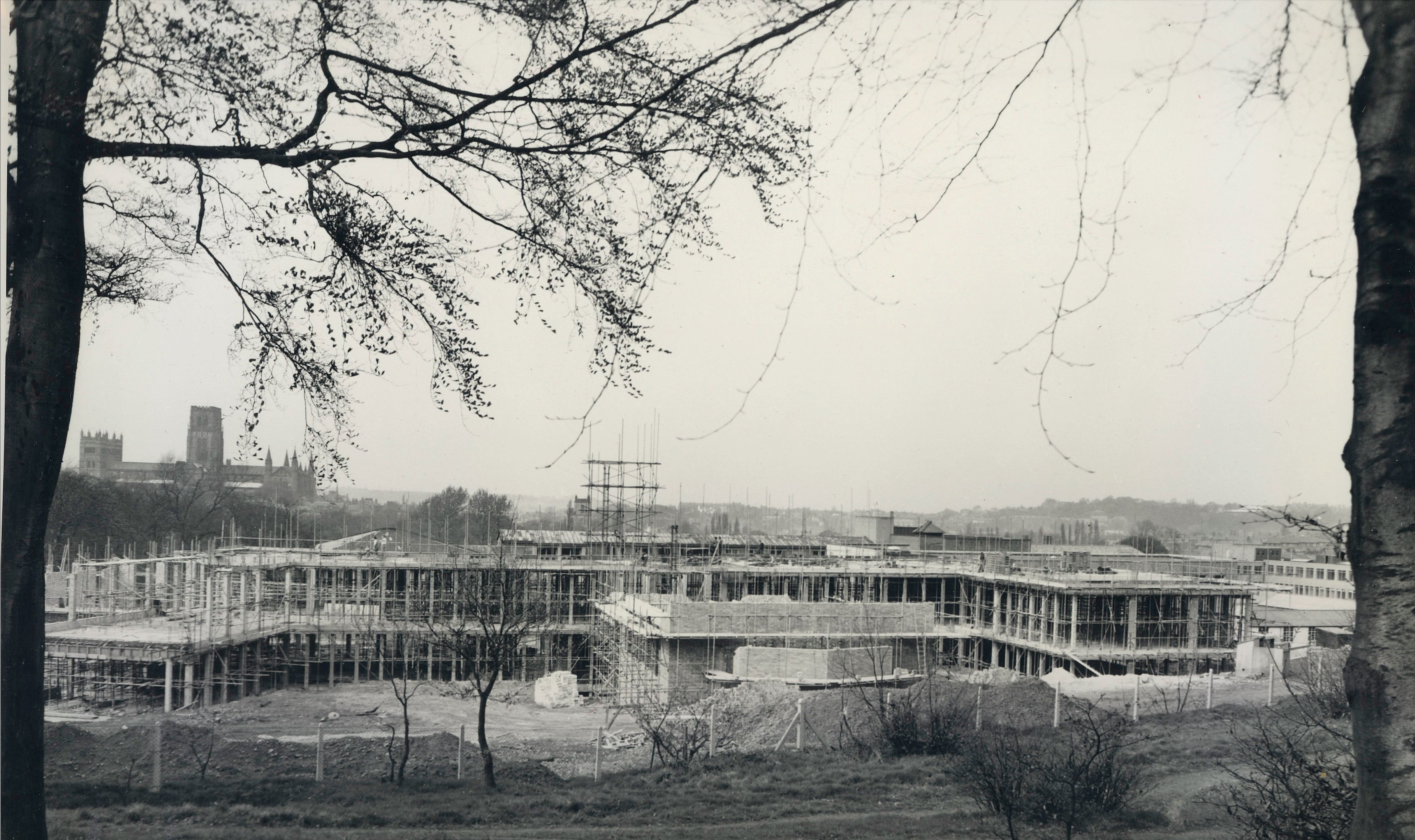 Image of the Rochester Building under construction, with a view of the Cathedral beyond