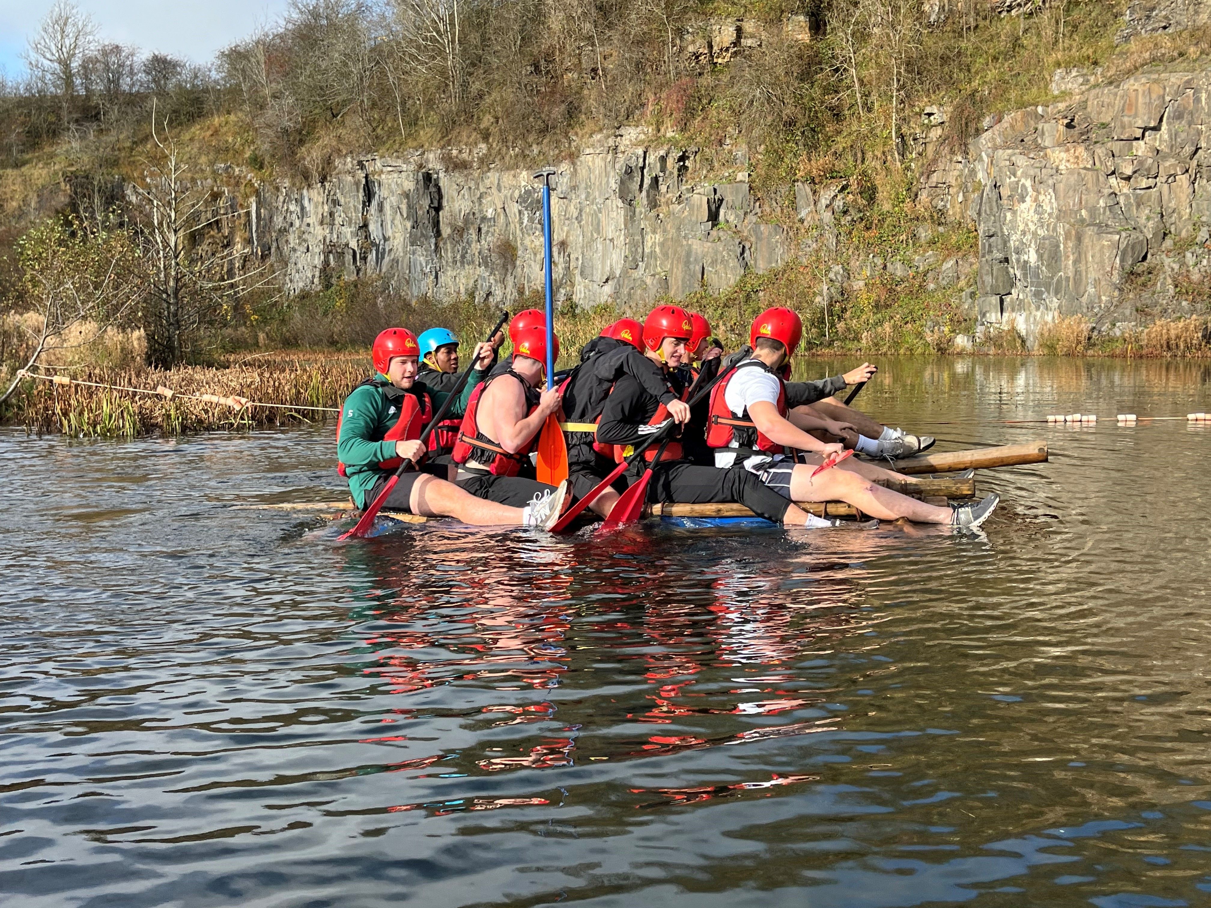 Students testing out a man-made raft on a river