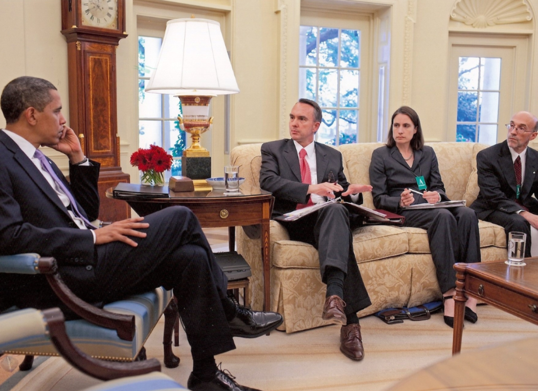 Dr Fiona Hill sitting in the Oval Office with Barack Obama and others