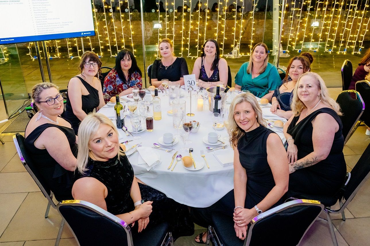 A group of people sat around a table