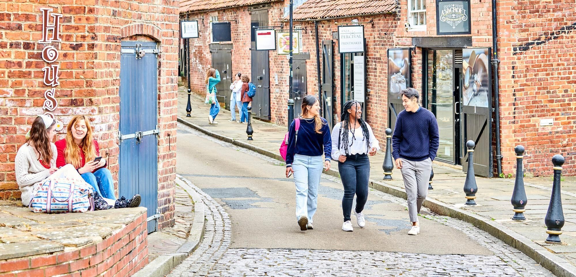 Students walking on a cobbled street