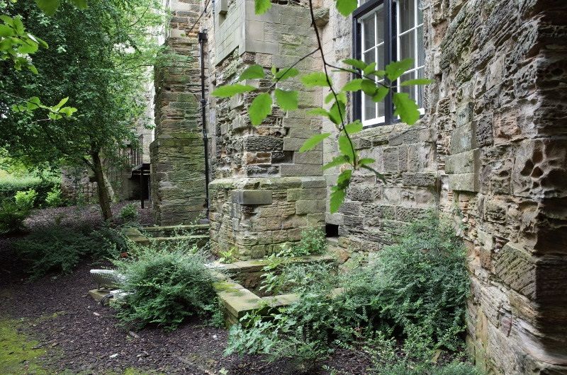 Exterior of the Norman Chapel before work began on the restoration project. The lightwells to the Chapel are visible on the right at ground level