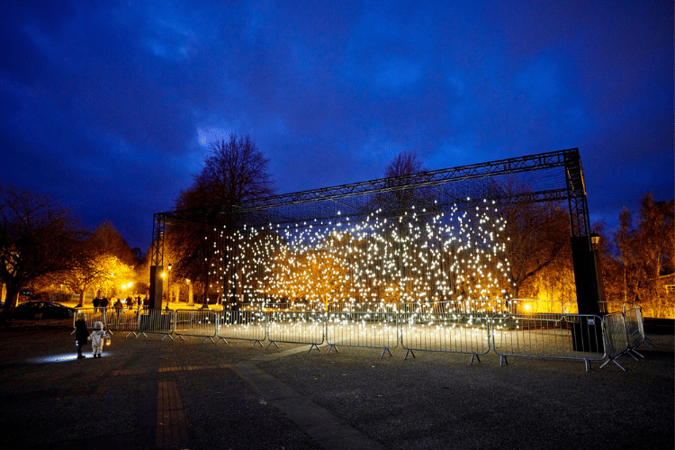 Illuminated scattered light bulbs hanging outside at St Marys College