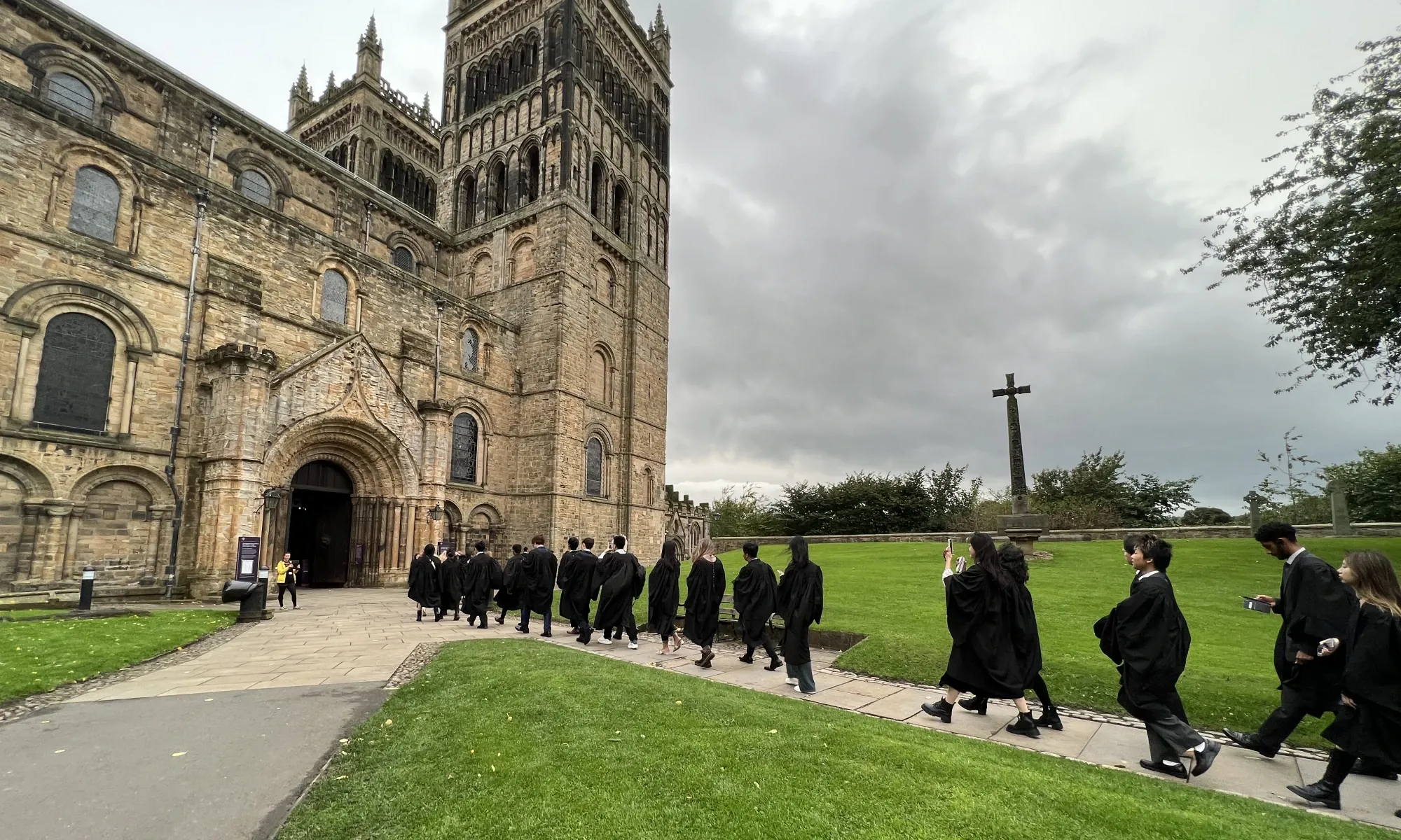 Students walking towards Durham Cathedral's North Door during Matriculation