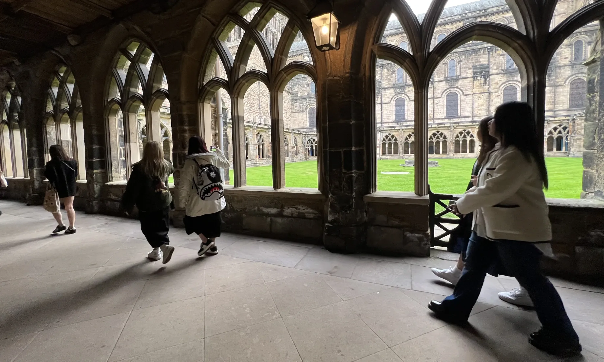 Students walking through Durham Cathedral Cloisters