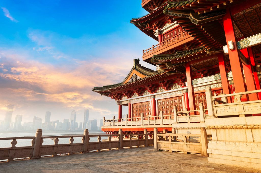 Ancient Chinese architecture with city skyline in background