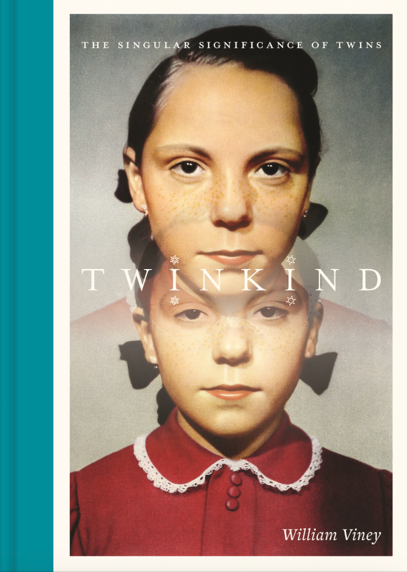 The cover of a book called Twinkind showing the faces of two identical young girls in a red dress