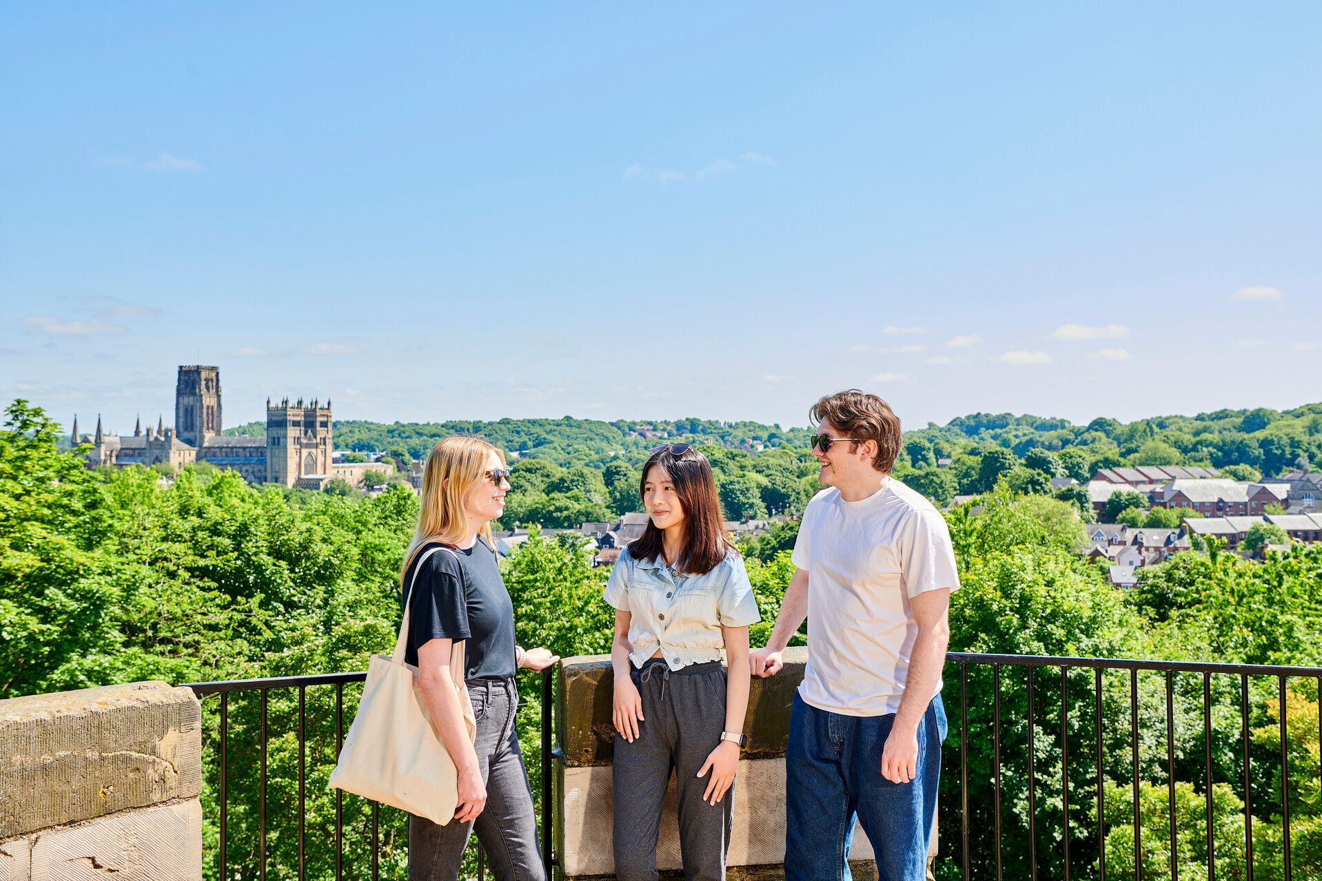 Student chatting with Durham and the Cathedral in the background